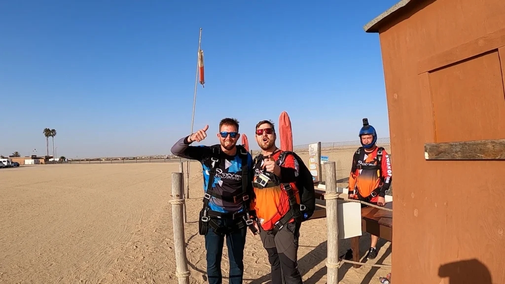 tandem skydiver passenger and instructor at dropzone preparing for first time skydive in Namibia
