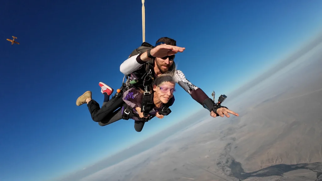 Tandem pair enjoying skydiving Namibia freefall with the desert below