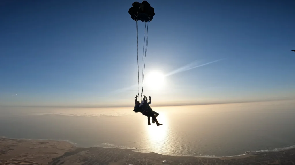 Tandem skydive Swakopmund pair open their canopy after exiting the aircraft