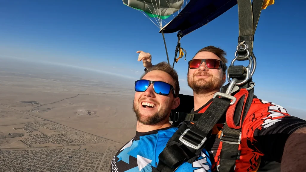 Two skydivers silhouetted against sunset on the Atlantic coast skydive route