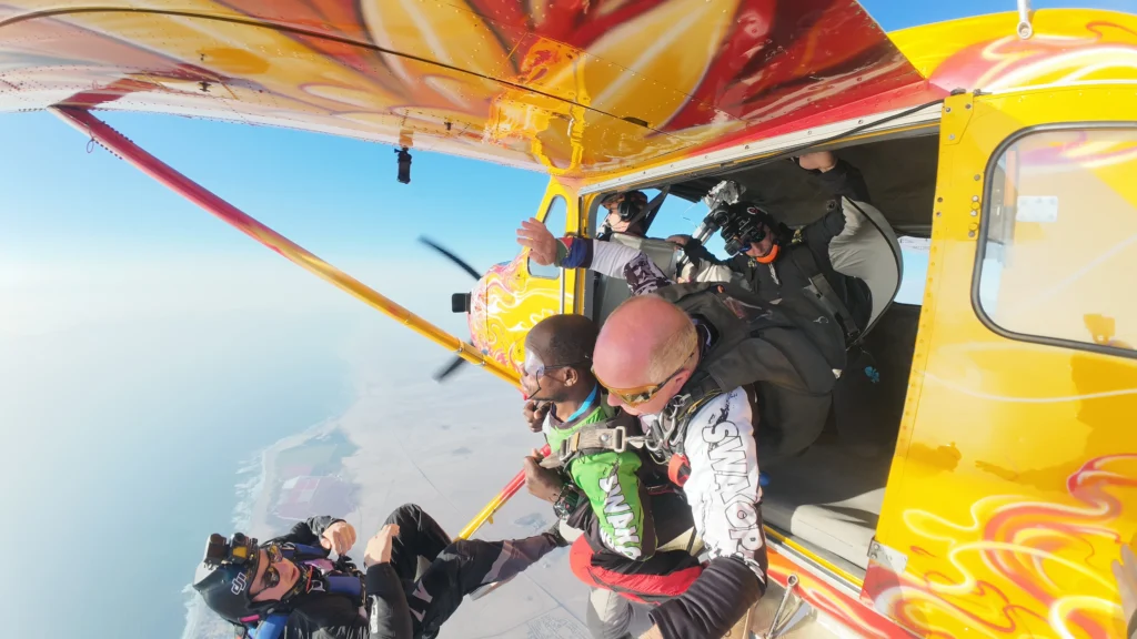 tandem skydive exit from aircraft over Swakopmund coastline