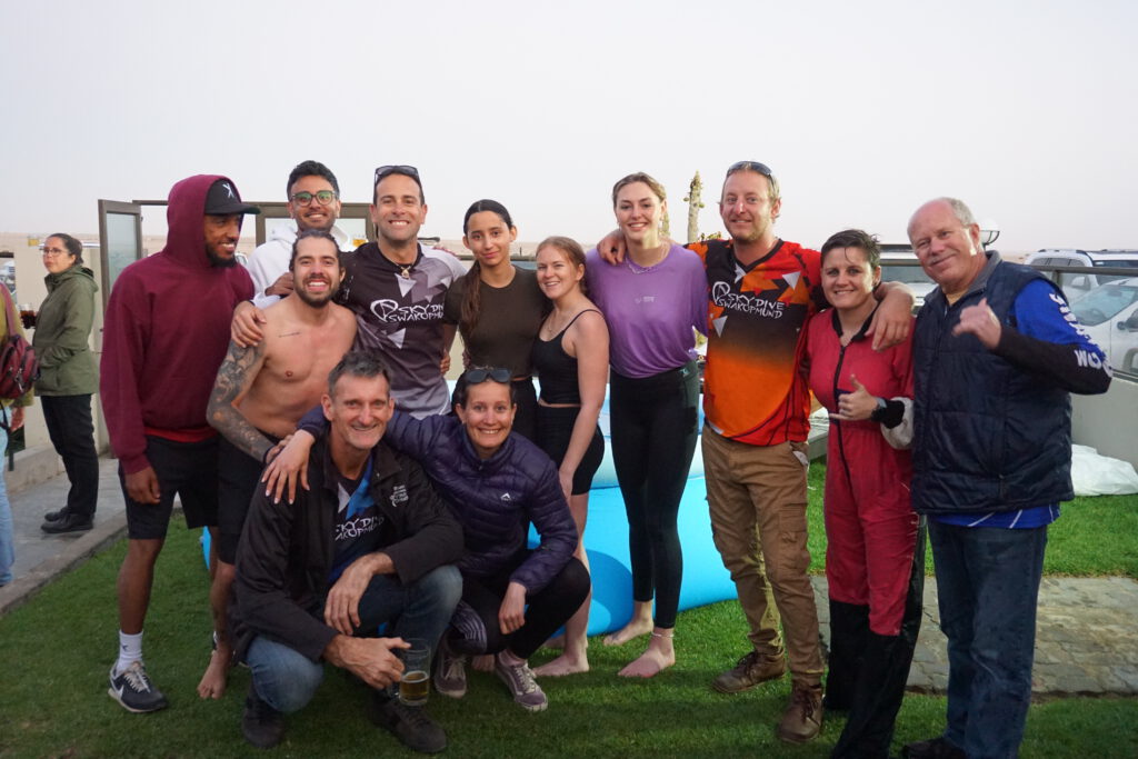 AFF students celebrating graduation with their instructors at Skydiving Swakopmund in Namibia