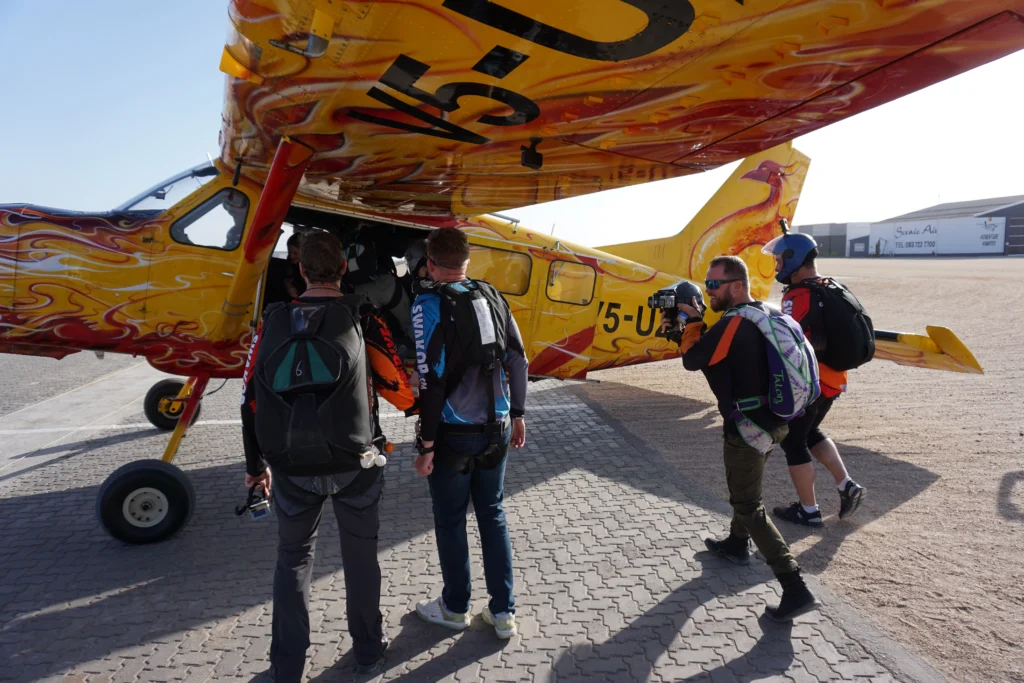 Skydivers board the jump plane on the tarmac, tandem skydive Swakopmund