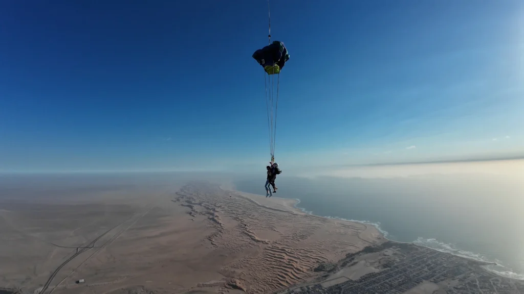 Tandem skydive descent over Swakopmund coastline with Namib Desert and Atlantic Ocean below