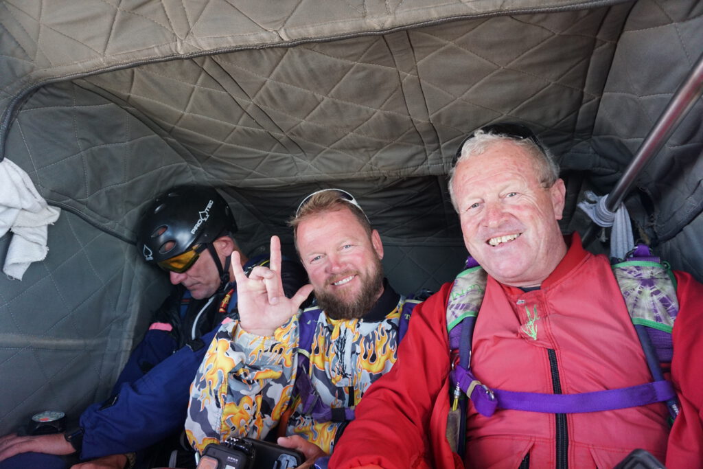 Three tandem skydive Swakopmund passengers smiling inside the aircraft cabin