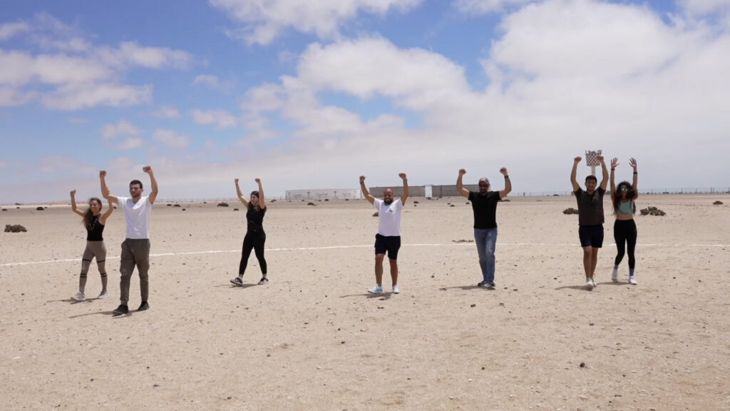 AFF students practice canopy steering arm movements on the desert airfield during solo skydiving training in Swakopmund