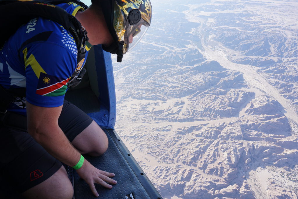 Professional skydiver looking down from the aircraft over Namibia’s Moon Landscape before exiting during the Euroinvasion event