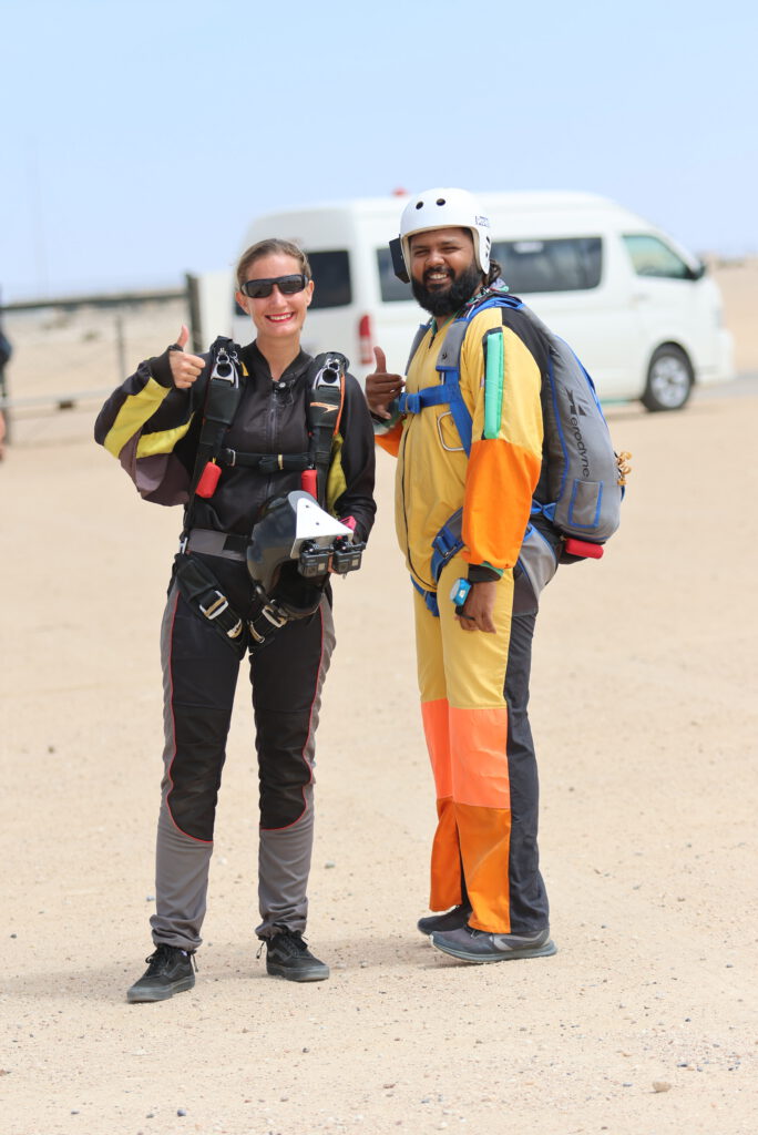 Solo skydiver and camera flyer celebrate after a skydiving Namibia jump together