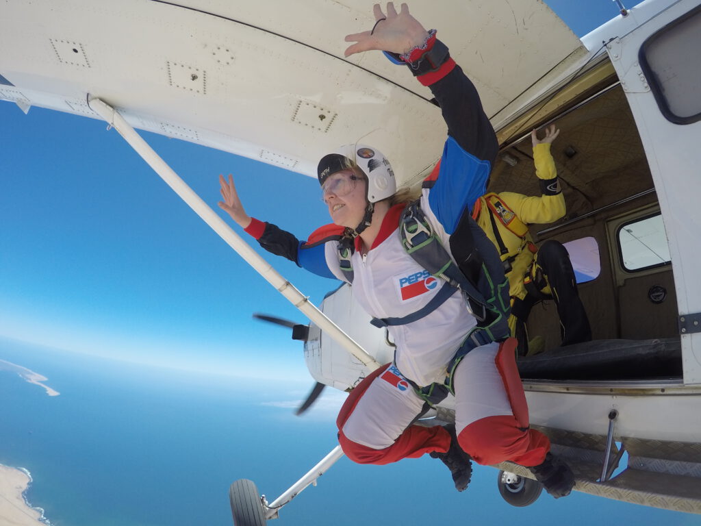 Static line student exiting the aircraft for a solo skydiving jump over the Swakopmund coastline.