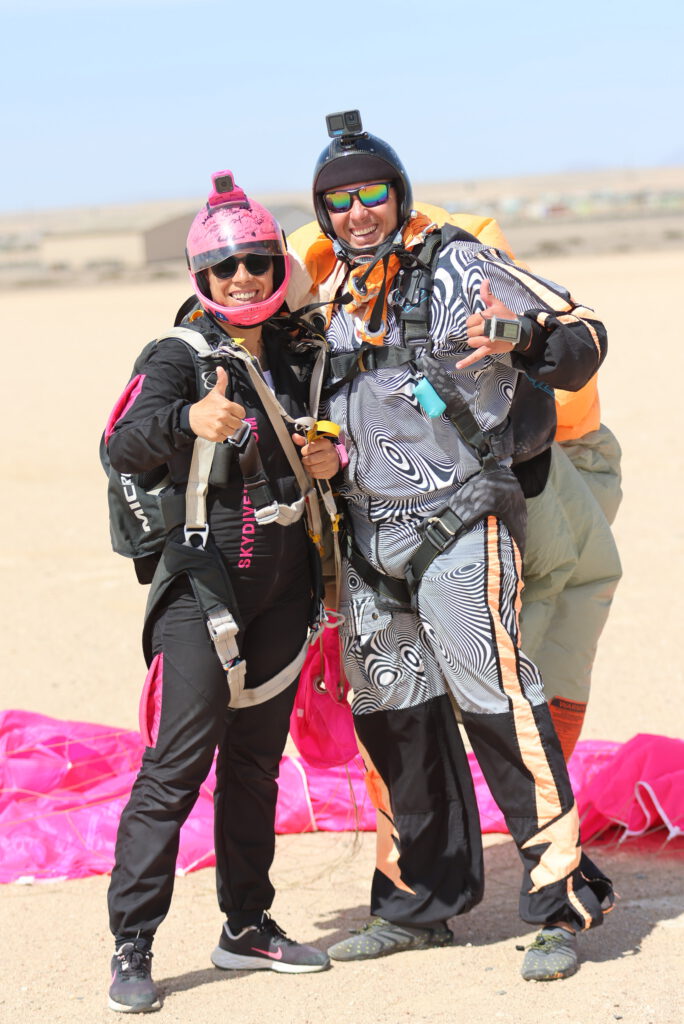 Tandem skydive Swakopmund instructor and passenger embrace after a successful landing